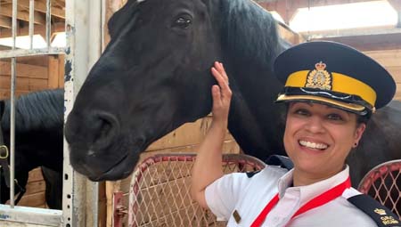 Inspector Veronica Fox posing with a Musical Ride Horse