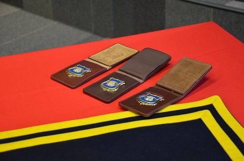 Three RCMP badges on a ceremonial table 