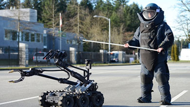 Robot arm reaching for explosives