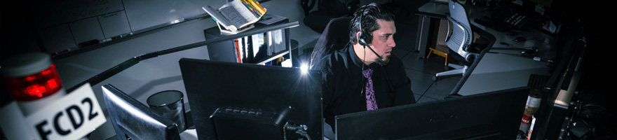 9-1-1 dispatcher sitting in front of several computer screens