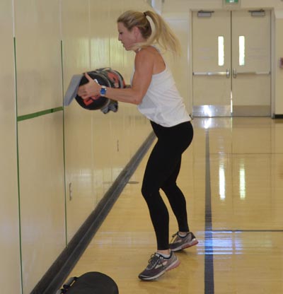 Female lifting weighted object