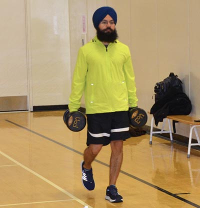 Man walking with weights in hand