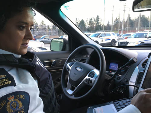 Cpl. Nav Hothi on duty in police car