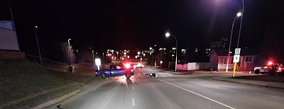 collision scene with a blue pickup truck and police vehicle with emergency lights on