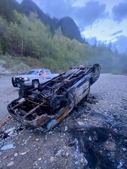 Photo of burnt vehicle on forest service road