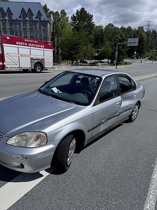 A picture of a Honda Civic which was side swiped on the Fern street overpass