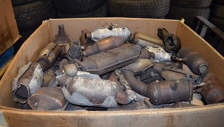 Catalytic converters piled in a box indoors