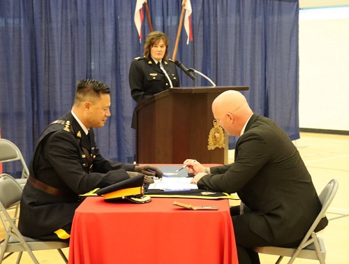 A member of EPO Troop #10 signing his engagement paperwork with the Human Resources Officer.