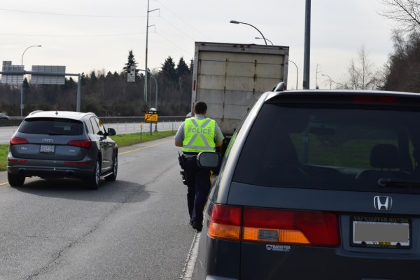 A BC Highway Patrol officer doing enforcement. March is Distracted Driving and Occupant Restraint month