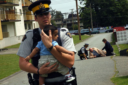 Member holding child in arms