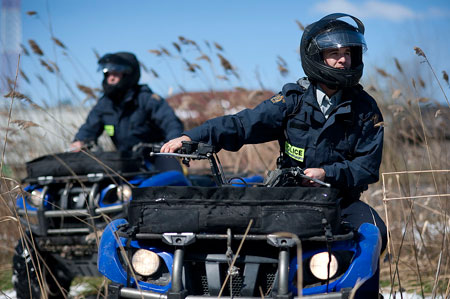 Two members on an ATV in field