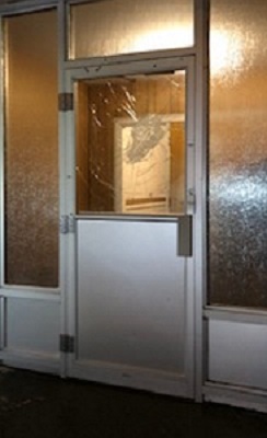 front entry door with damage to glass