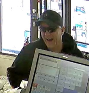 Man smiling with black Unit.Co hoodie, sunglasses and ball cap 