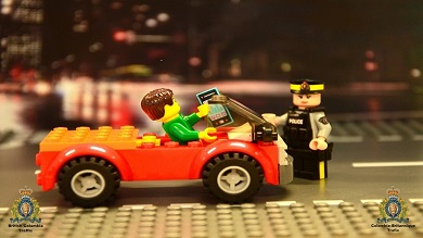 Lego car with driver holding phone, Lego RCMP officer standing by car