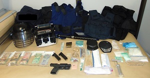 Photo of illegal drugs, firearm and body armour.
