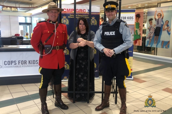 Photo taken at the 2019 Jail & Bail which shows Cst. Dan Carson (left) & Cpl. Jesse O’Donaghey (right) pose with Cops for Kids Director Shawna Lundin of Argus Properties Ltd.;