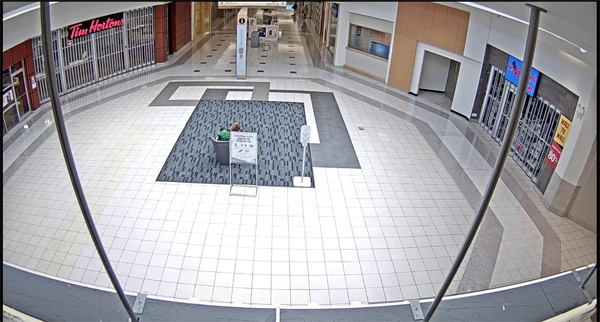 Image of Surrey Central City Mall – Rotunda. Mr Doucette is seated in a chair