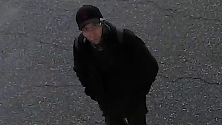 Photo of the suspect wearing a ball cap, black pants and a dark jacket