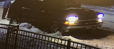Vehicle suspected to be an early 2000's Chevrolet Tahoe, dark coloured potentially purple or maroon.