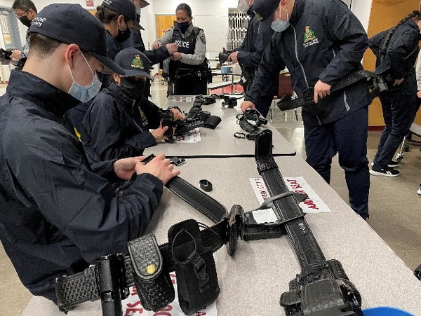 A photo of students preparing police belts for duty.