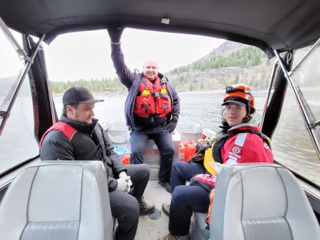 Cst Heim and two members of Columbia Search and Rescue are on a boat.