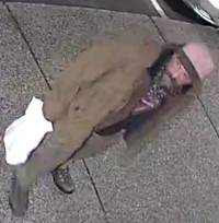 The suspect is described as a white man, approximately 50 years of age, with a moustache and goatee, wearing a black Rolling Stones shirt, green pants, dark boots, a beige jacket and toque.