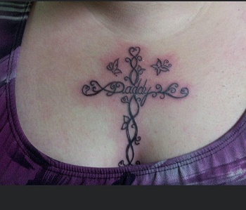 Photo of tattoo on missing person’s chest: cross with word <q>Daddy</q> in center