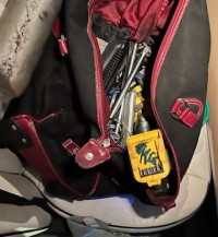 Photo of a tool bag with random tools inside.