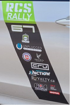 RCS Rally decal sticker on car door with various sponsors such as Unplugged Performance, CRU, Junction, Royalty.ca, 604 and Motul