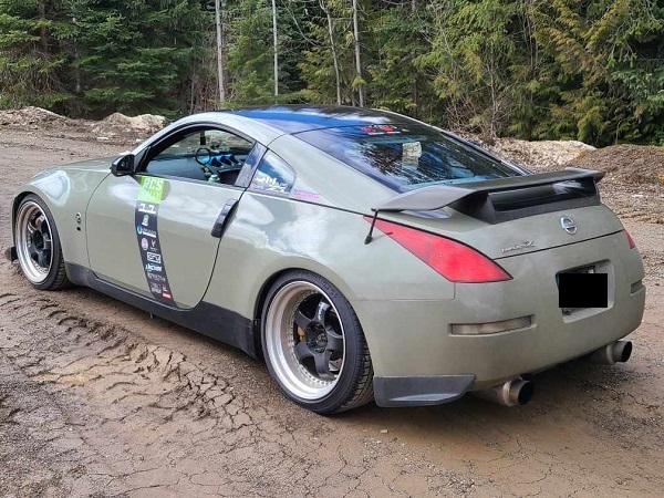 Olive green Nissan with RCS Rally decal on driver's door