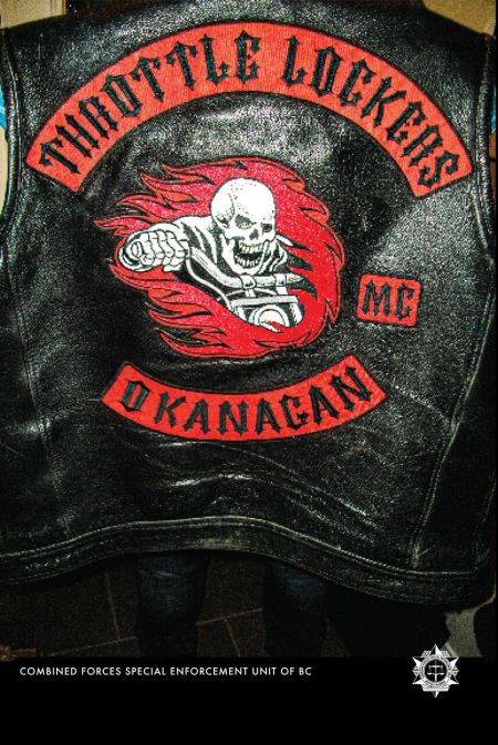 Vest: The back of a black leather vest. A vest has a red banner with black writing that states Throttle Lockers on the top, MC on the right, and Okanagan underneath. In the middle is an image of a skeleton holding motorcycle handle bars, surrounded by red flames. The words Combine Forces Special Enforcement Unit of BC and a logo are written in small write letters on the bottom of the image. 