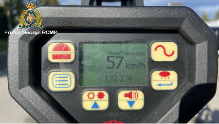 Photo of a handheld radar device showing a vehicle traveling at 57km/hr