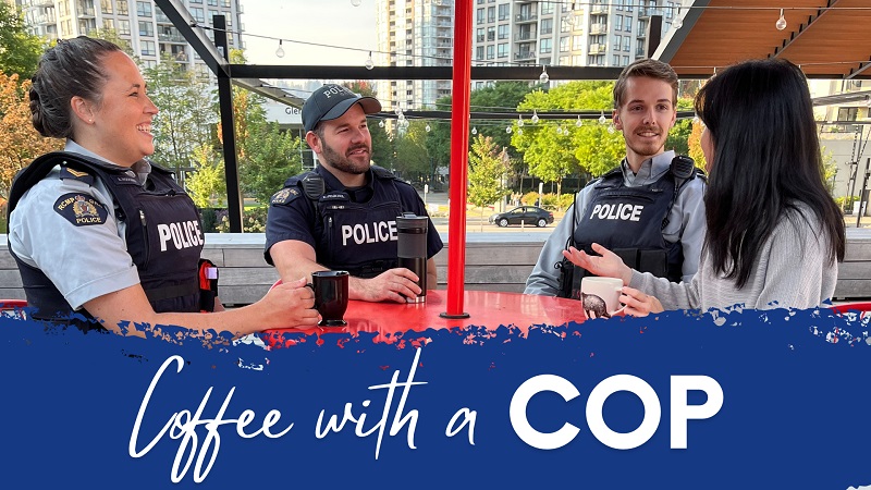 Police officers enjoying coffee with a member of the public