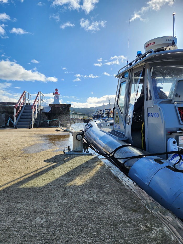 RCMP patrol vessel docked near a light house