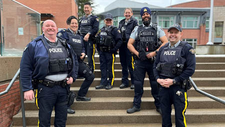 Seven Youth RCMP officers in uniform standing on stairs