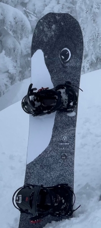 the stolen snowboard and bindings. The snowboard is black and white with the design or an orca whale. 