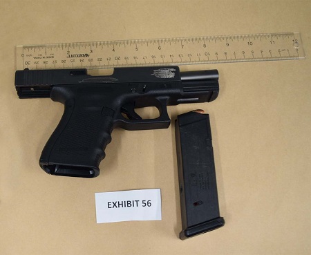 Black handgun with unattached loaded magazine