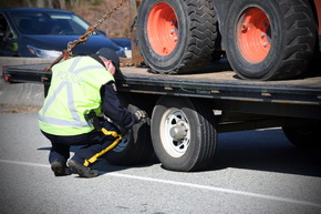 police officer inspecting tires on vehicle