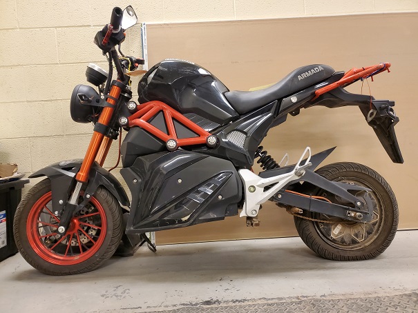 2020 Armada, electric motorcycle, black and orange in colour.