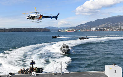 Air 5 helicopter in air over ERT boats in water