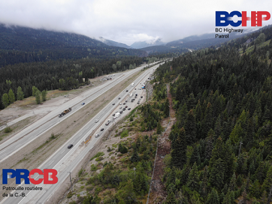 Aerial view of a police road check at a truck pullout area on the highway.