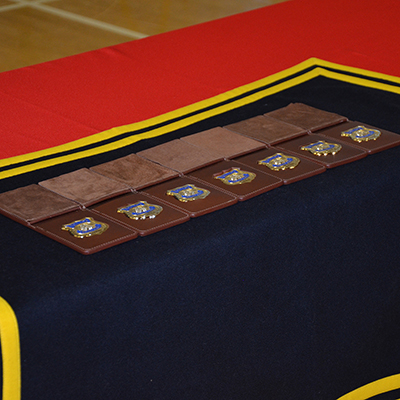 row of RCMP badges placed on a table.