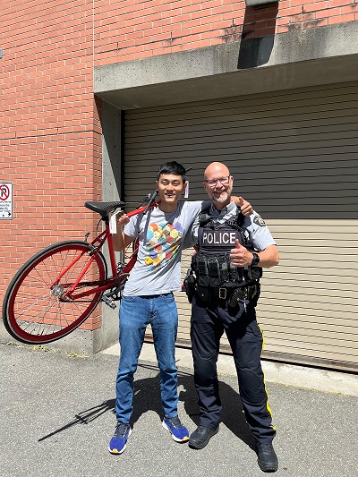 Owner, Joey Zhad and Constable Glenn Tjernagel with returned stolen red bike