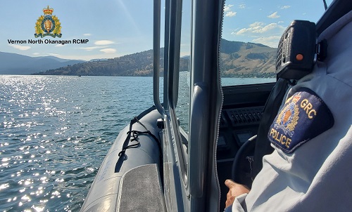 photo of RCMP officer on boat on lake