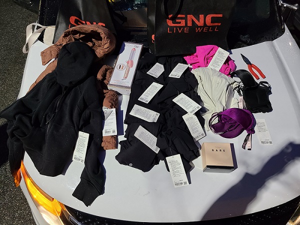 Photo of recovered clothing and other items, some still with tags. 