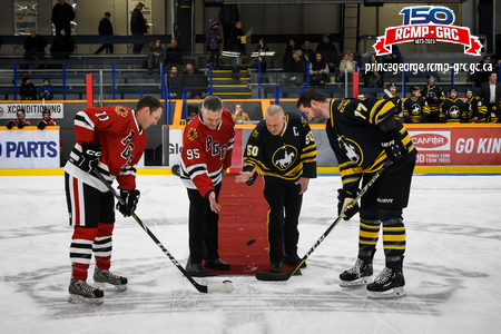 Photo of the ceremonial puck drop with the team captains, Superintendent Wright and Fire Chief Warner.
